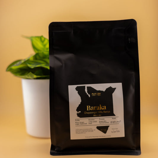 Black coffee bag with 'Baraka' anaerobic fermenation kenyan coffee label on a yellow background